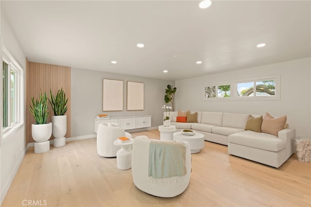 living area featuring light wood-style floors, baseboards, and recessed lighting