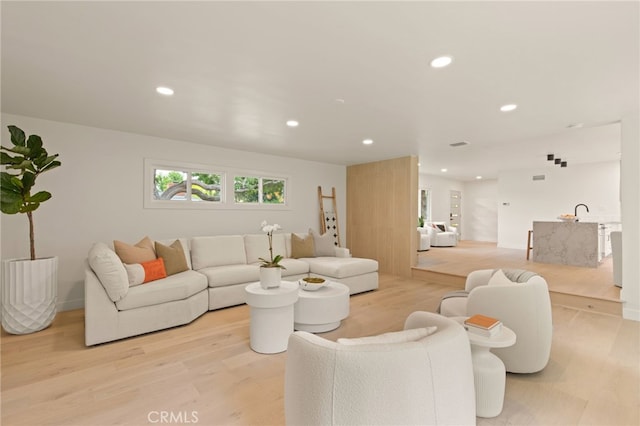 living area featuring recessed lighting and light wood-style flooring