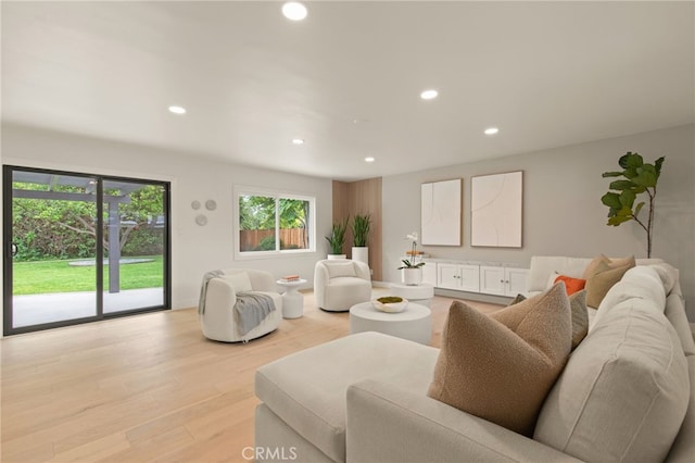 living area with recessed lighting and light wood-style flooring
