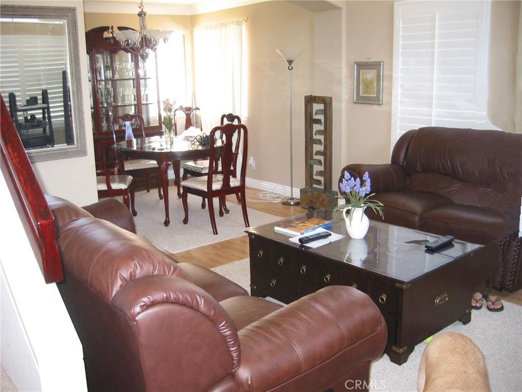 13 Santa Monica St, Aliso Viejo, CA 92656 - living room featuring baseboards, wood finished floors, and a chandelier