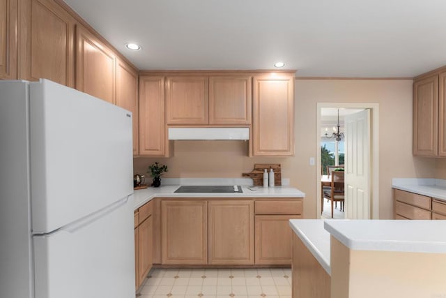 kitchen with freestanding refrigerator, recessed lighting, under cabinet range hood, and light countertops