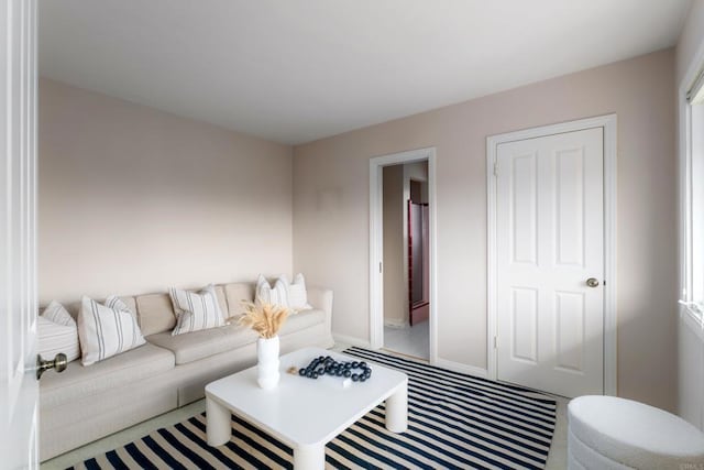 carpeted living room with baseboards