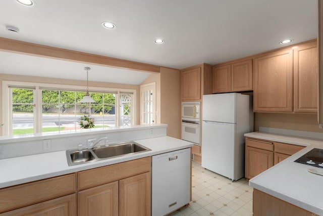 kitchen featuring white appliances, light floors, light countertops, a sink, and vaulted ceiling
