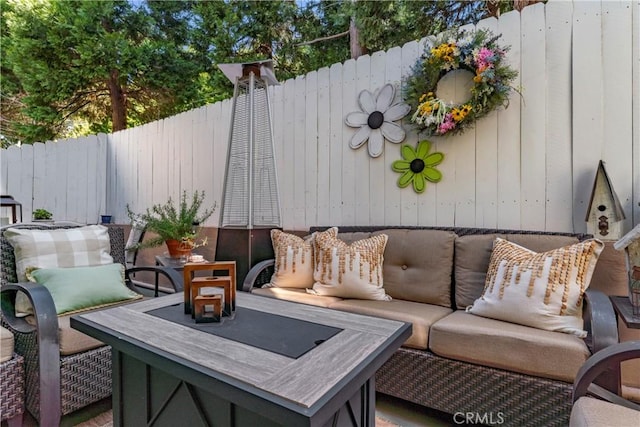 view of patio with an outdoor living space and fence