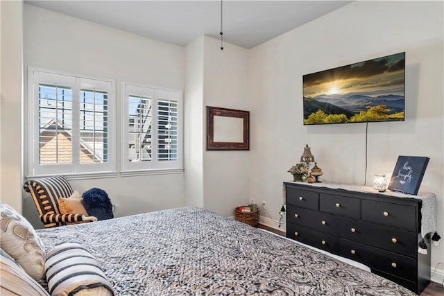bedroom featuring baseboards and wood finished floors