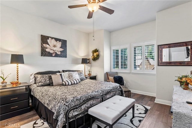 bedroom with baseboards, ceiling fan, and wood finished floors