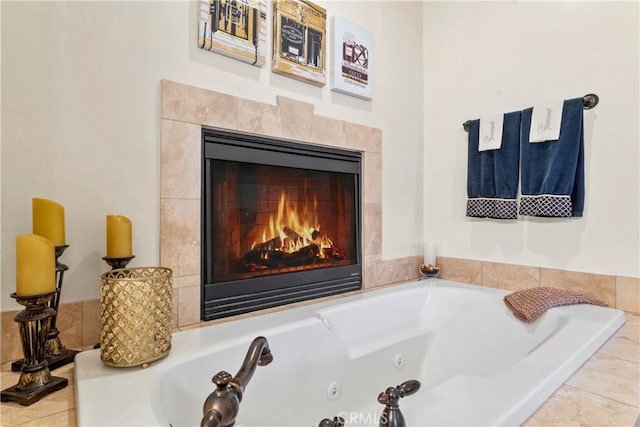 bathroom featuring a tiled fireplace and a jetted tub