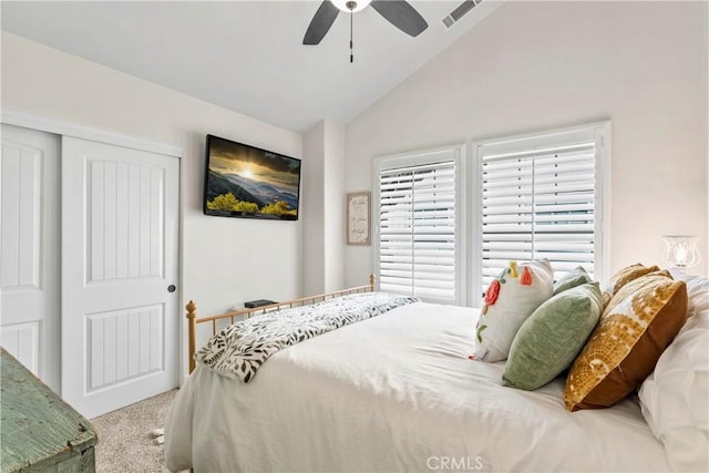carpeted bedroom featuring visible vents, a ceiling fan, a closet, and lofted ceiling