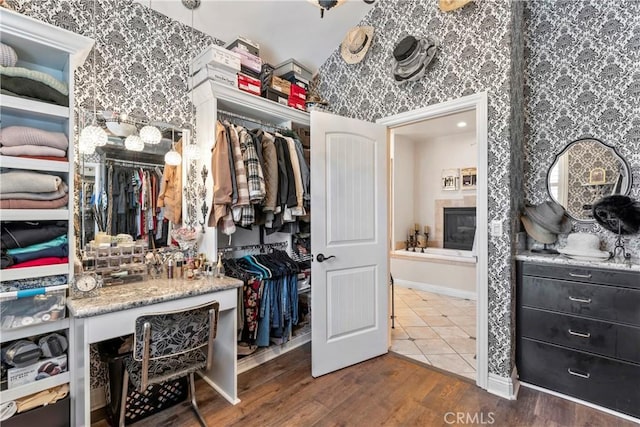 walk in closet featuring wood finished floors
