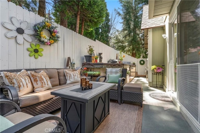 view of patio / terrace with an outdoor living space and fence