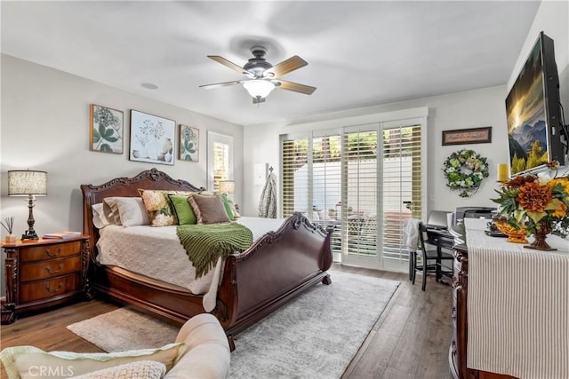 bedroom with access to outside, wood-type flooring, and ceiling fan