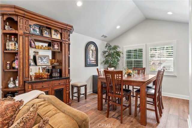 dining area featuring recessed lighting, visible vents, light wood finished floors, and vaulted ceiling