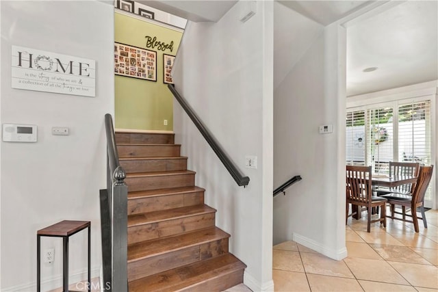 stairway with tile patterned flooring and baseboards