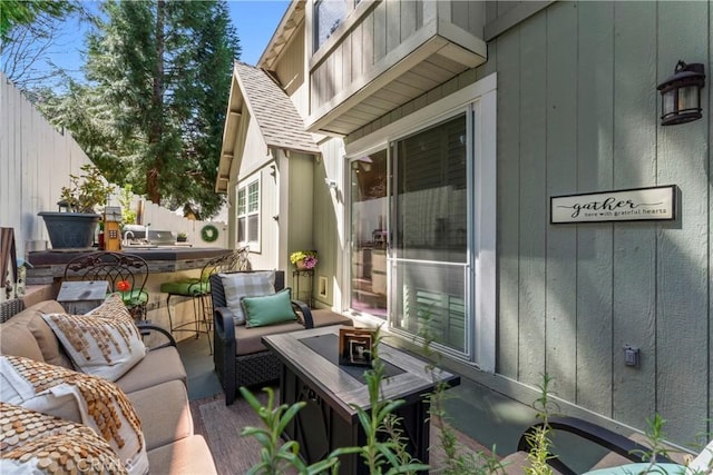 view of patio / terrace featuring an outdoor living space and fence