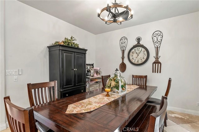 dining room featuring baseboards, a chandelier, and light tile patterned floors
