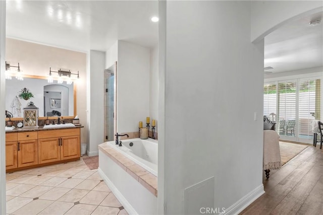 bathroom featuring vanity, tile patterned floors, a garden tub, and a stall shower