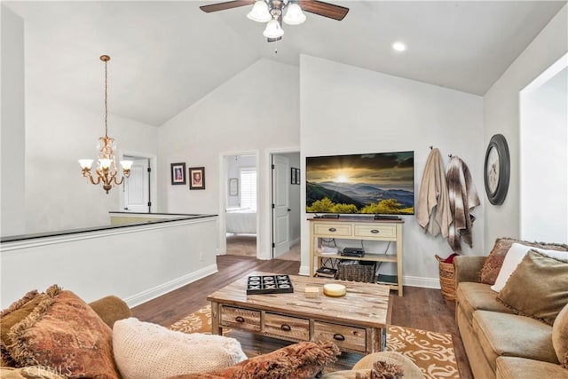 living area featuring baseboards, ceiling fan with notable chandelier, and wood finished floors