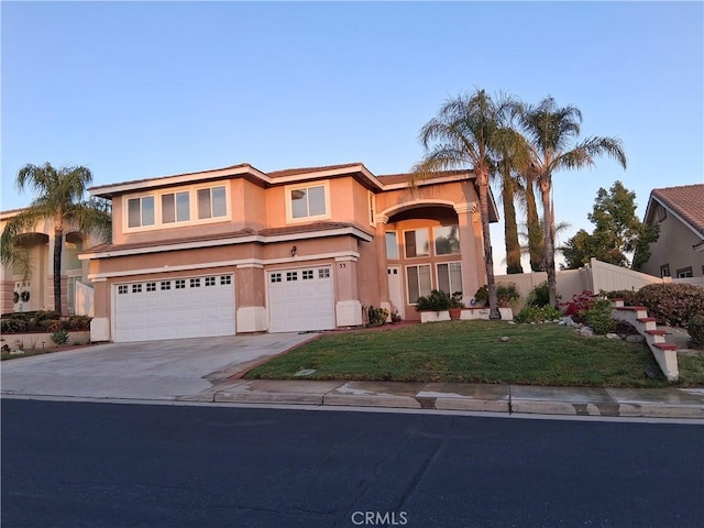 33 Corte Rivera, Lake Elsinore, CA 92532 - mediterranean / spanish home featuring an attached garage, driveway, and stucco siding