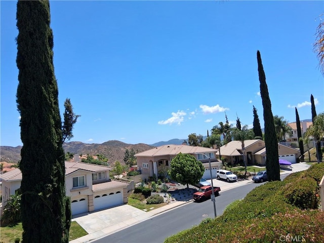 33 Corte Rivera, Lake Elsinore, CA 92532 - view of asphalt street featuring a residential view, a mountain view, curbs, and sidewalks