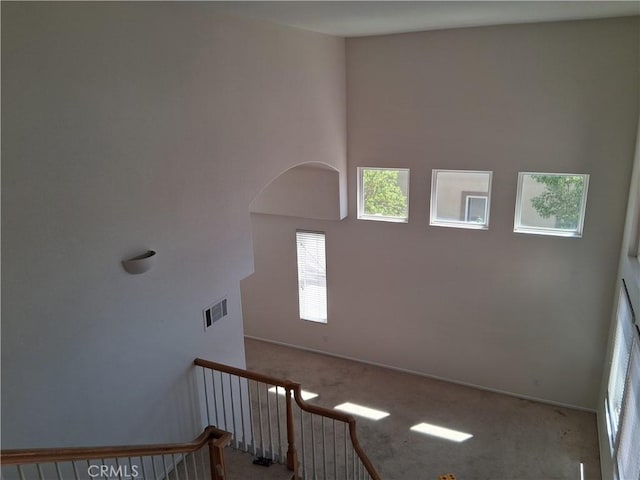 33 Corte Rivera, Lake Elsinore, CA 92532 - staircase featuring carpet floors, a high ceiling, and baseboards