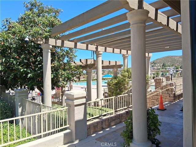 33 Corte Rivera, Lake Elsinore, CA 92532 - view of patio / terrace with a pergola, a community pool, and a mountain view