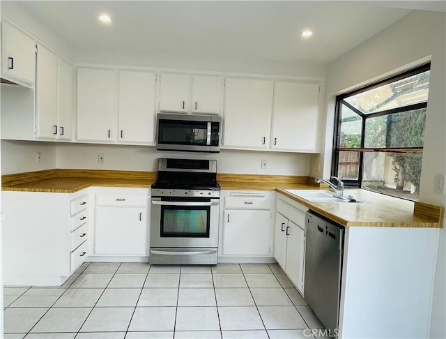 835 Plumwood St, Colton, CA 92324 - kitchen with light countertops, white cabinets, a sink, appliances with stainless steel finishes, and light tile patterned floors