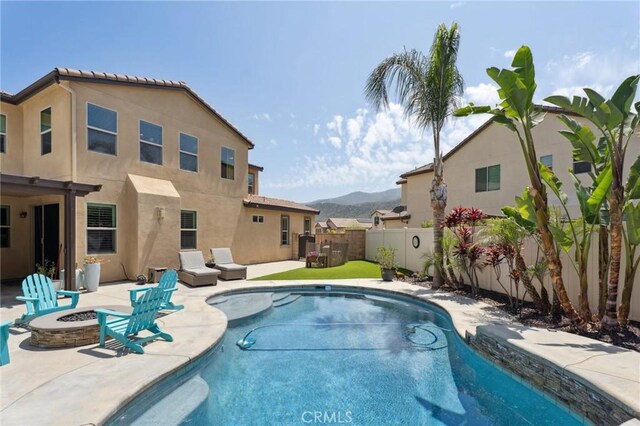 11266 Hutton Rd, Corona, CA 92883 - view of pool featuring an outdoor fire pit, a fenced backyard, a mountain view, and a patio area