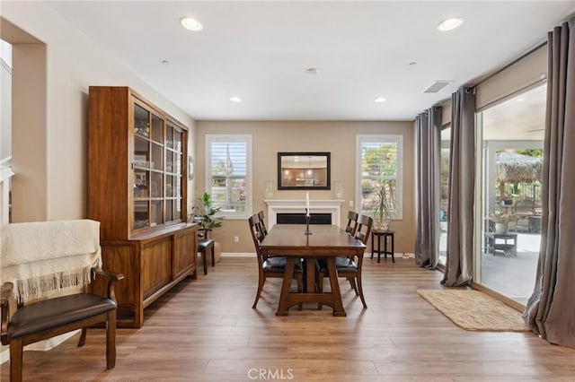dining area featuring plenty of natural light, light wood-style floors, baseboards, and recessed lighting