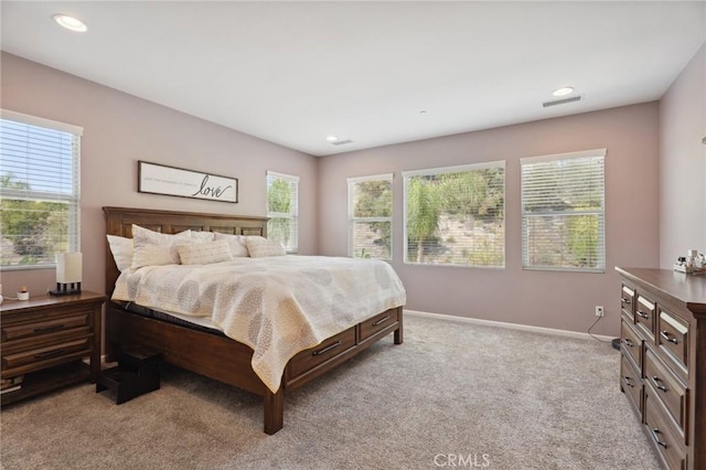 bedroom featuring light carpet, baseboards, and recessed lighting