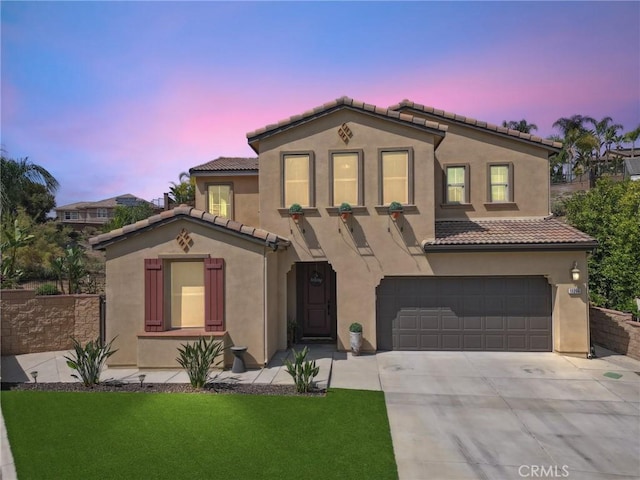 11266 Hutton Rd, Corona, CA 92883 - mediterranean / spanish-style house featuring an attached garage, driveway, a tiled roof, stucco siding, and a front lawn