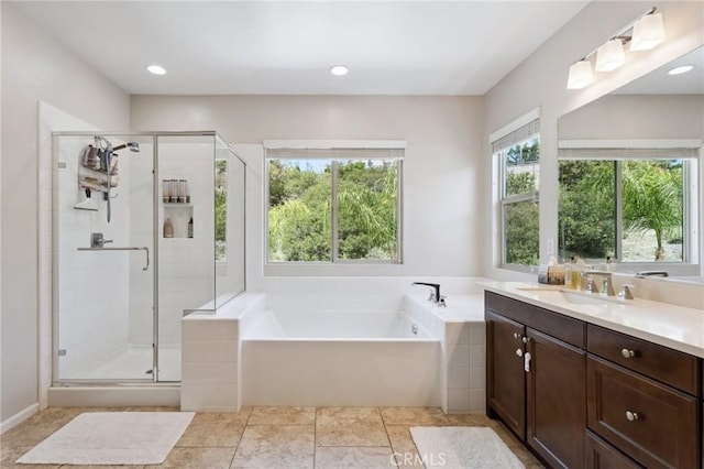full bathroom featuring vanity, a bath, and a shower stall