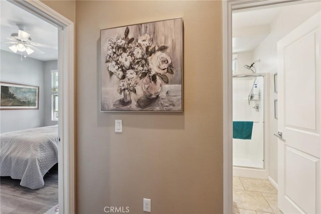 hall featuring baseboards and tile patterned floors