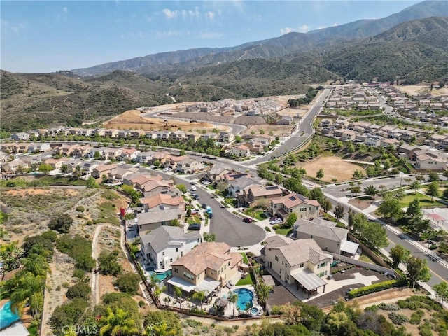 aerial perspective of suburban area with a mountain backdrop and a pool area