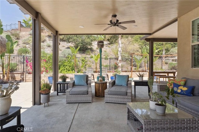 view of patio / terrace featuring a fenced backyard, ceiling fan, and an outdoor living space