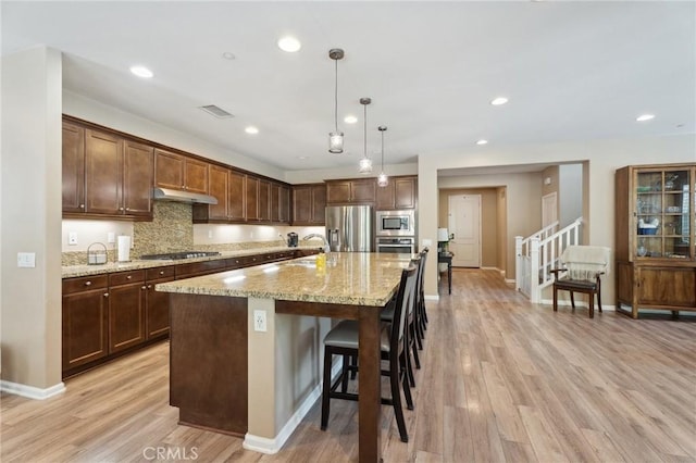 11266 Hutton Rd, Corona, CA 92883 - kitchen with appliances with stainless steel finishes, light wood finished floors, light stone counters, tasteful backsplash, and recessed lighting