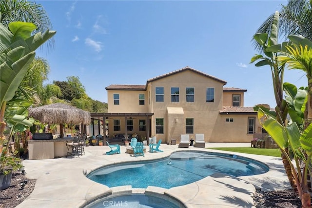 11266 Hutton Rd, Corona, CA 92883 - view of pool featuring a pool with connected hot tub, a patio area, and a ceiling fan
