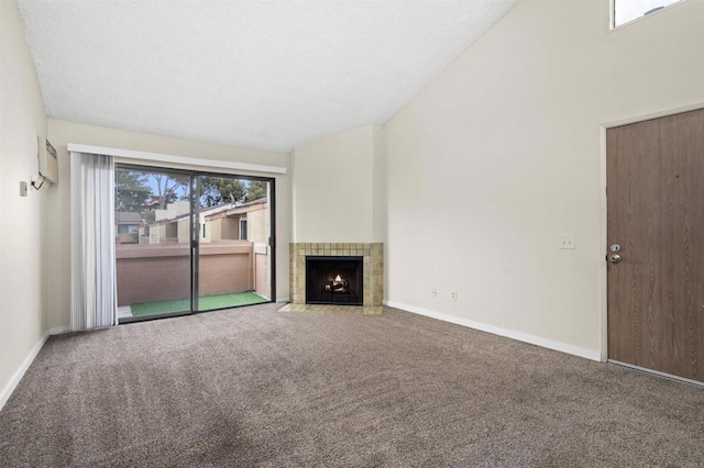 unfurnished living room with baseboards, carpet, and a tile fireplace