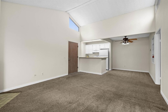 unfurnished living room featuring high vaulted ceiling, baseboards, a ceiling fan, and carpet flooring
