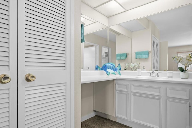 bathroom with vanity and baseboards