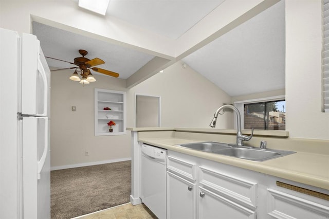 kitchen with light colored carpet, vaulted ceiling, a sink, light countertops, and white appliances