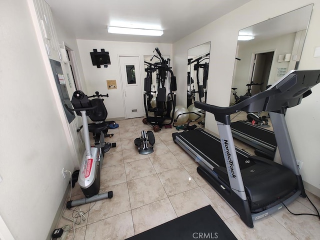 workout room featuring light tile patterned flooring