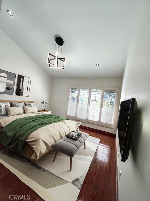 bedroom with recessed lighting, wood finished floors, and vaulted ceiling