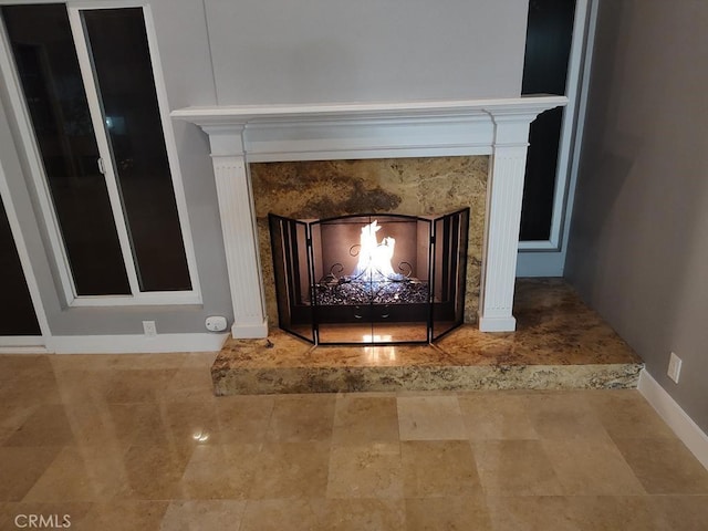 details with baseboards and a fireplace