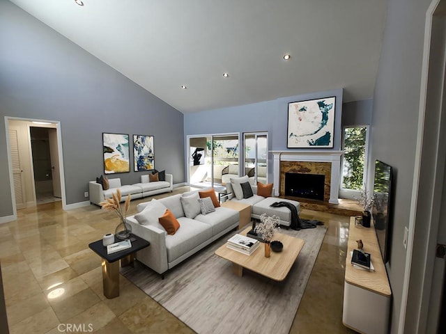 living room featuring recessed lighting, high vaulted ceiling, baseboards, and a fireplace