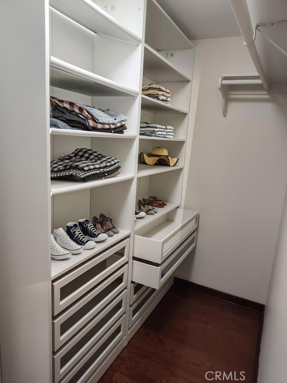 walk in closet featuring dark wood-type flooring