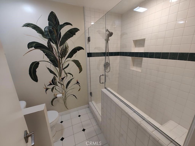 full bathroom with baseboards, tile patterned flooring, a shower stall, and toilet