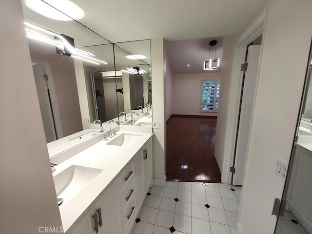 bathroom with double vanity, tile patterned floors, and a sink