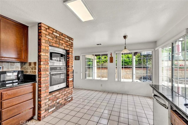 6322 E E W View Dr, Orange, CA 92869 - kitchen featuring stainless steel appliances, backsplash, a textured ceiling, and plenty of natural light