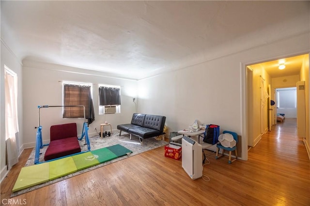 rec room with wood finished floors and cooling unit