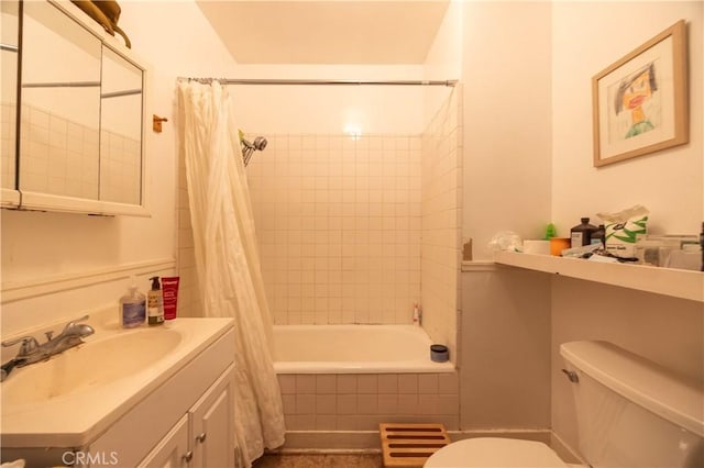 bathroom featuring tiled shower / bath combo, vanity, and toilet